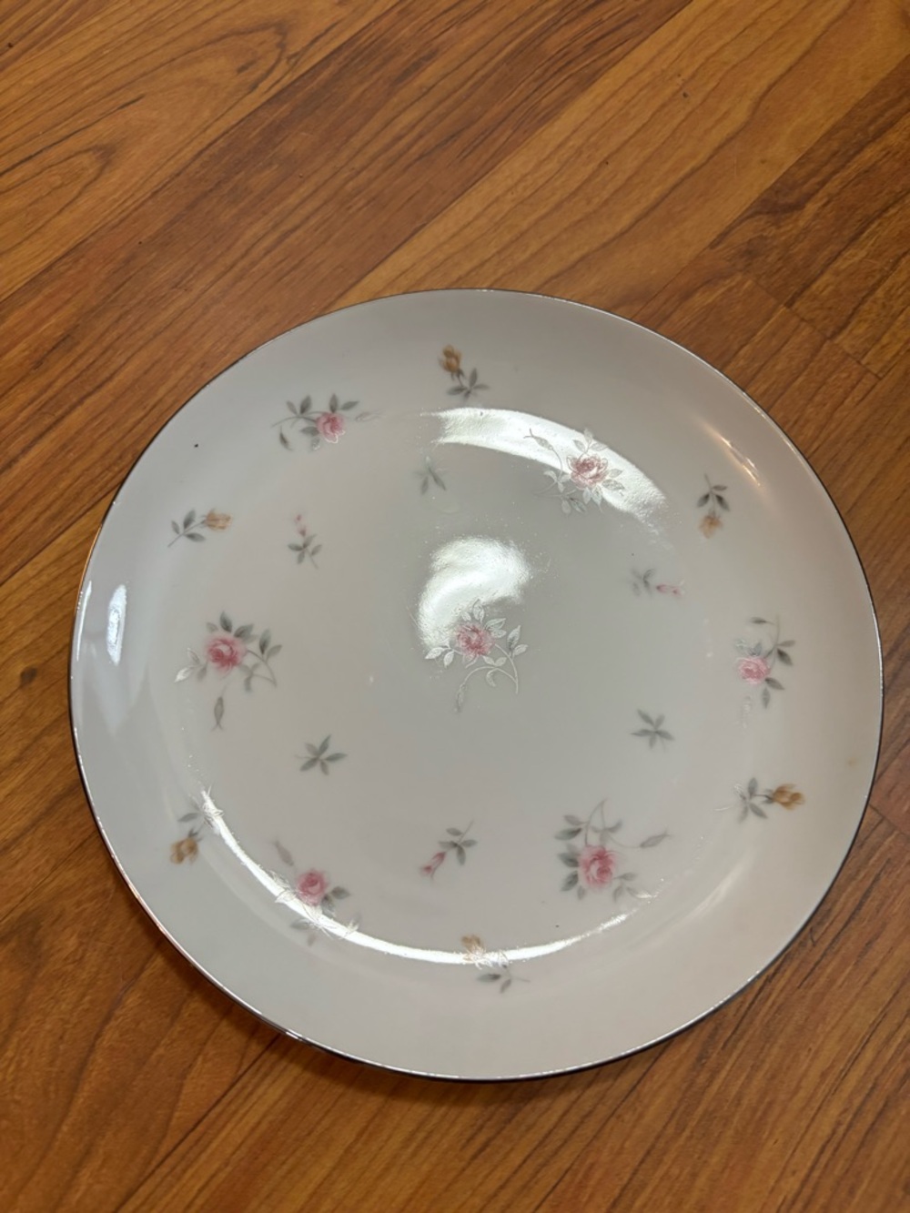 Classic white China salad plate with pink and yellow scattered rosebuds.